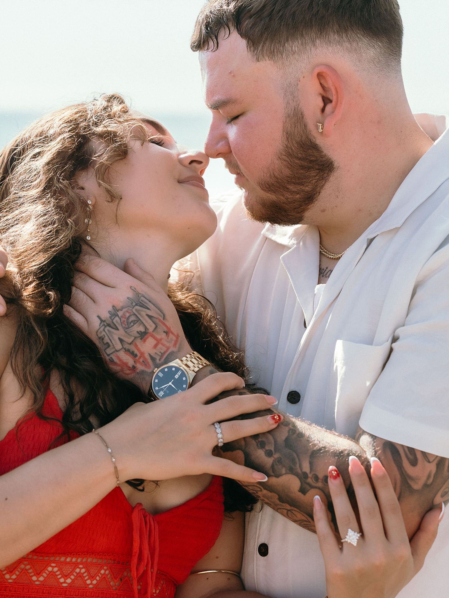 A romantic couple shares intimate moments on the beach.