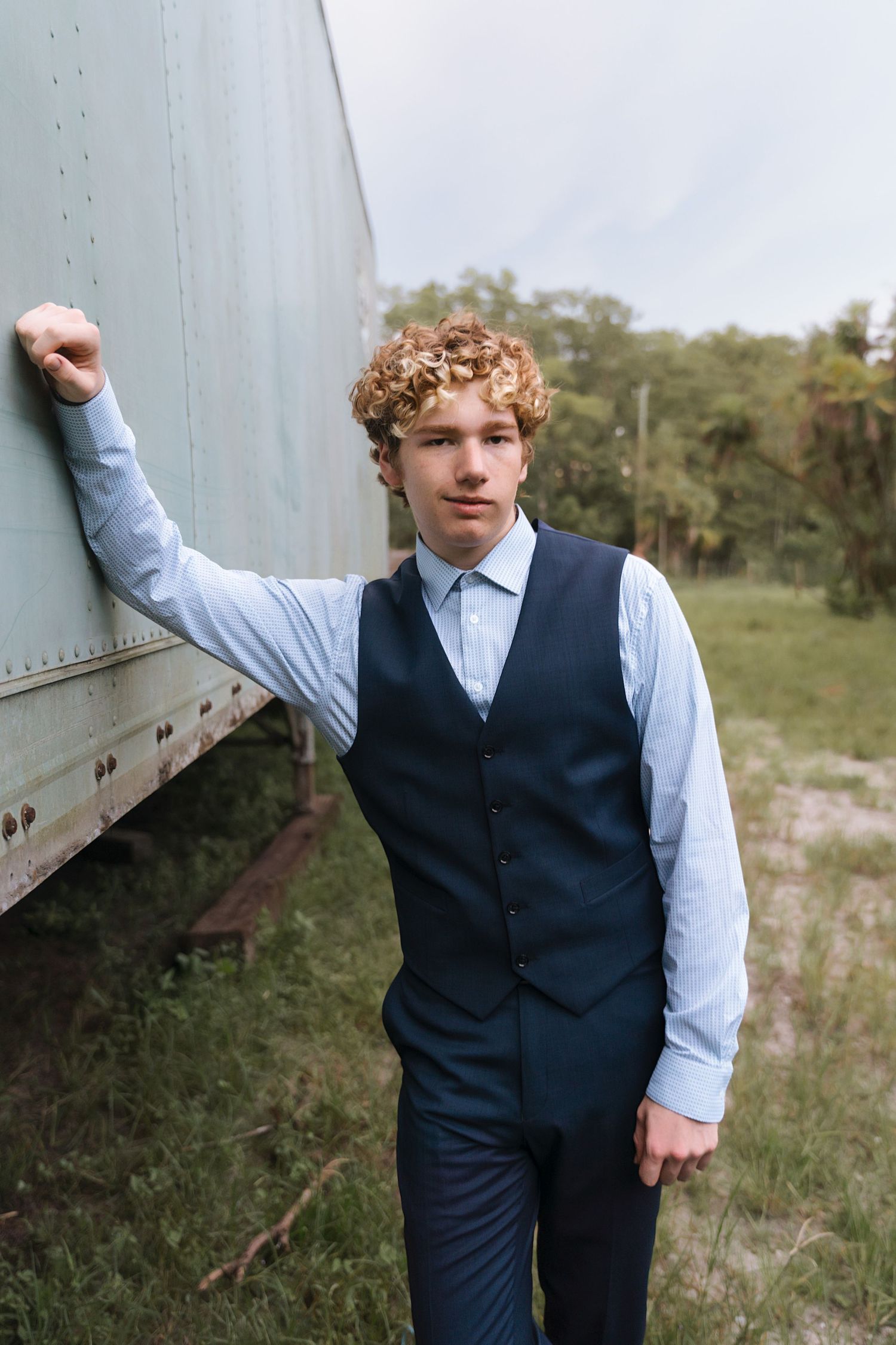Dynamic poses in business casual attire against an industrial backdrop.