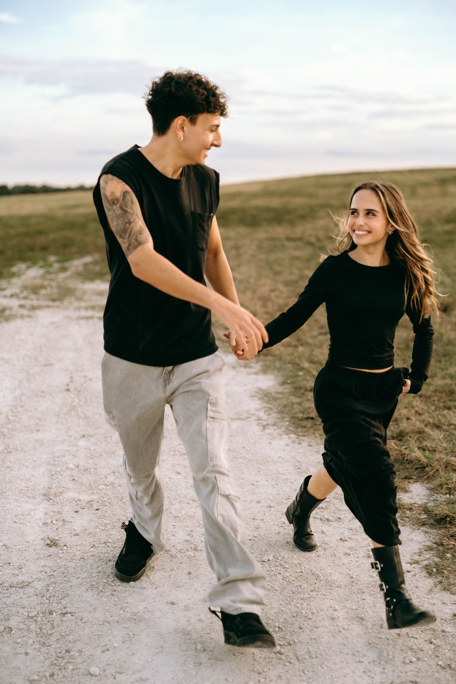 A playful sequence of dance moves between two people on a dirt path.