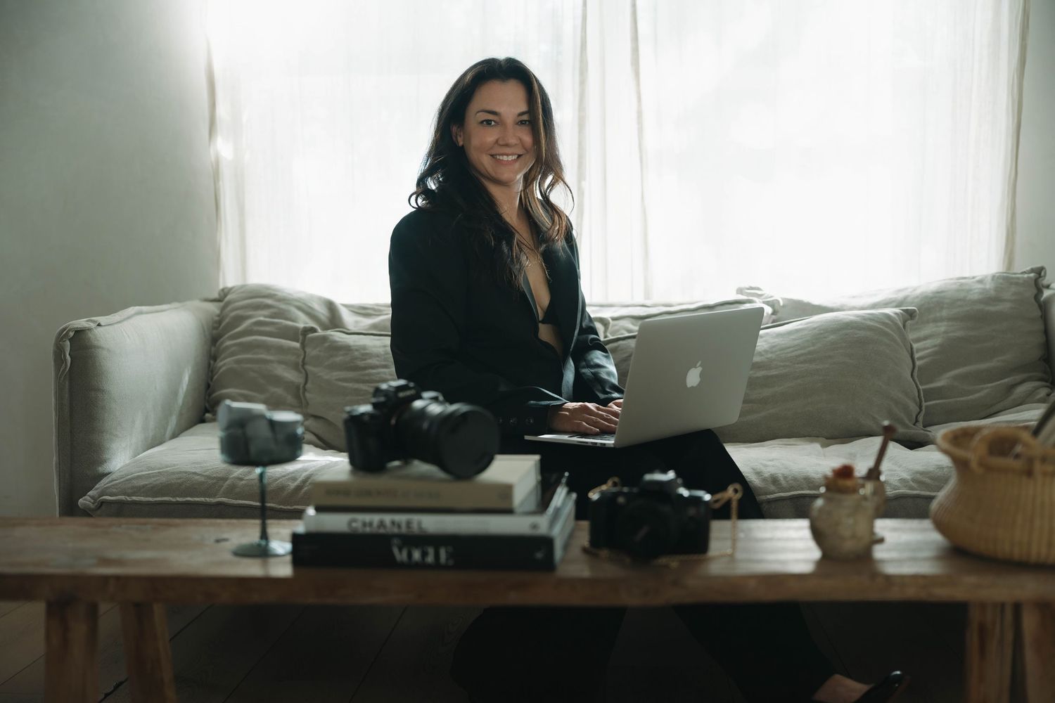 Interior scene with person working on laptop in bright, modern living space.