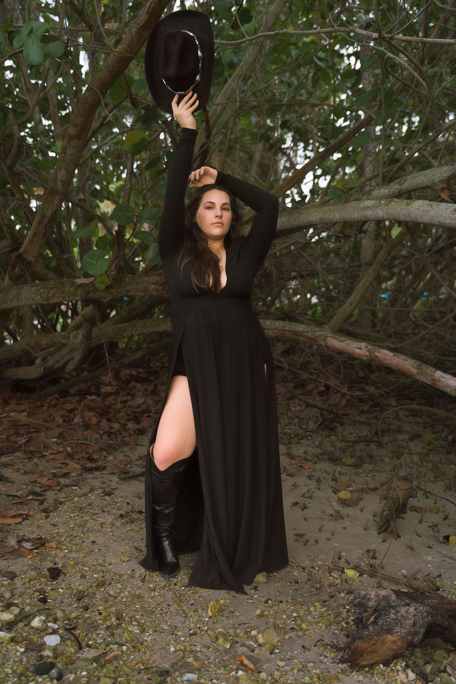 Artistic portrait series under tree branches showing movement in flowing black dress.