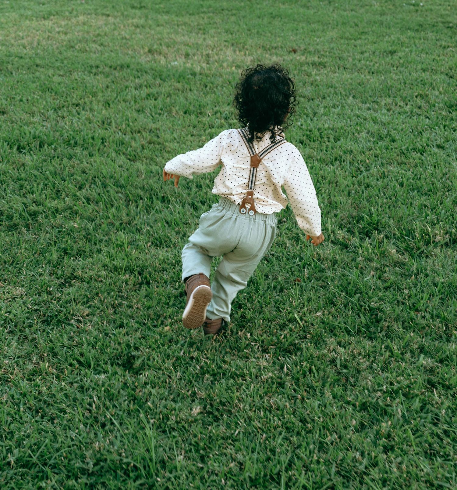 People playing and having fun on a green lawn during a photo session.