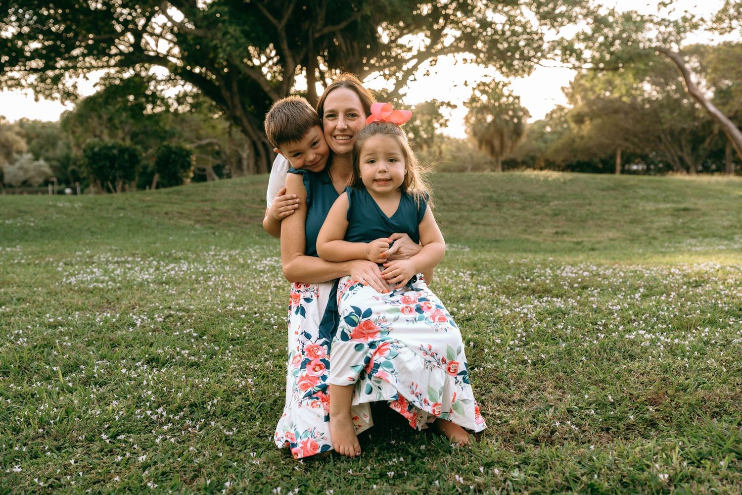 Family members enjoying a summer evening outdoors near a traditional home.