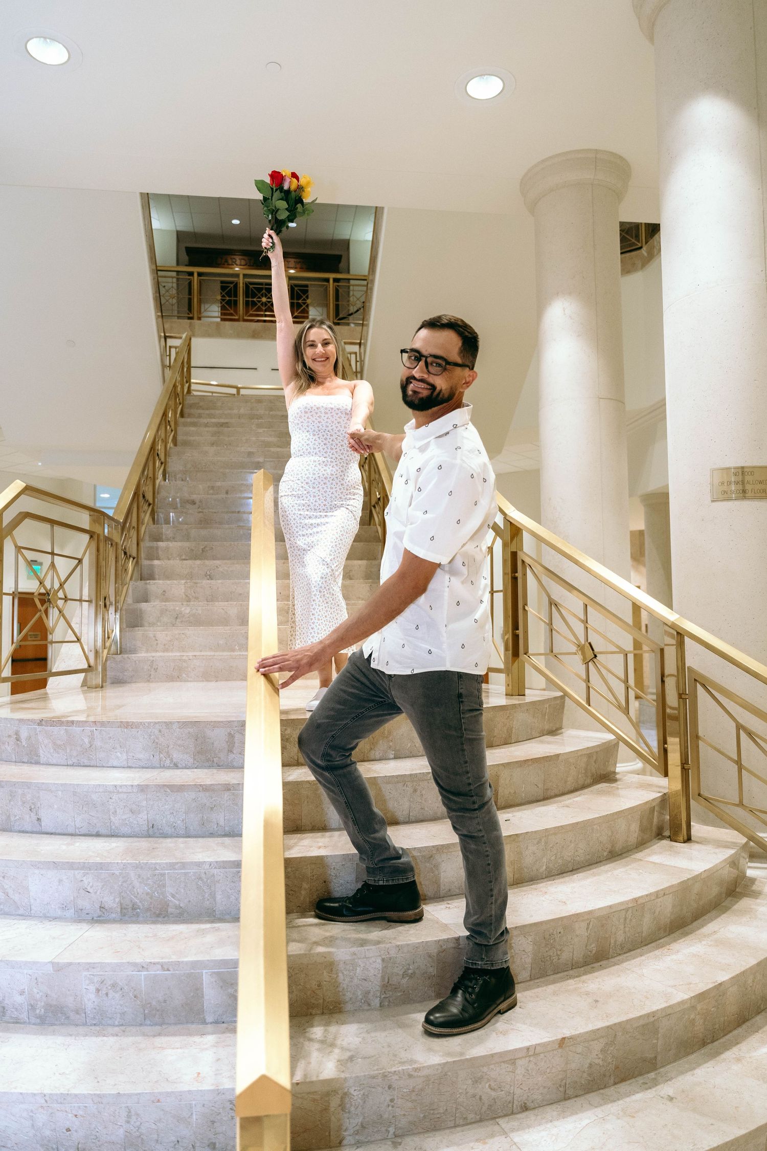Sequential photos showing someone walking up curved marble stairs with gold railings in an elegant interior.