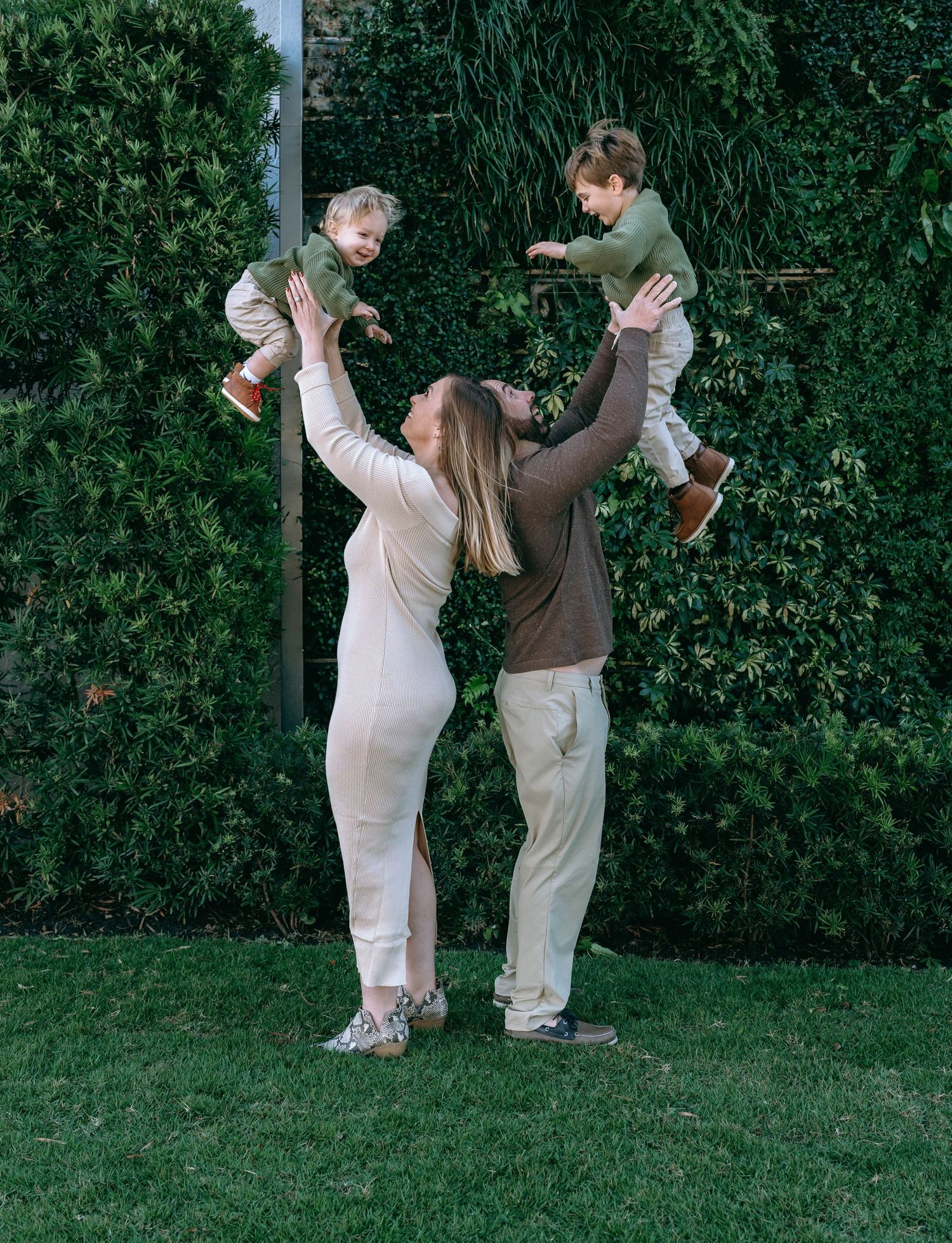 Candid sequence of people dancing and having fun in front of a green hedge.