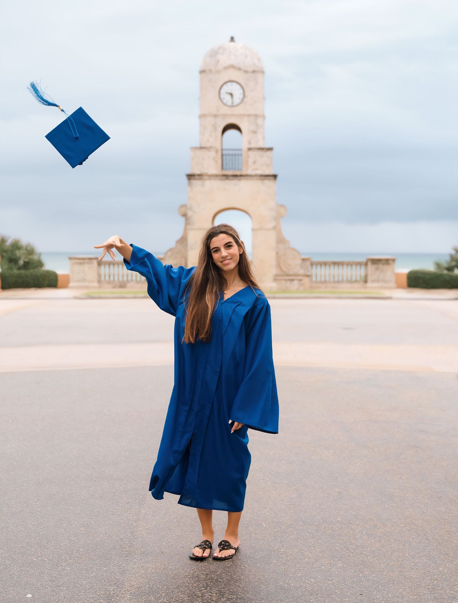 Graduation celebration photos with blue cap and gown at historic memorial site.
