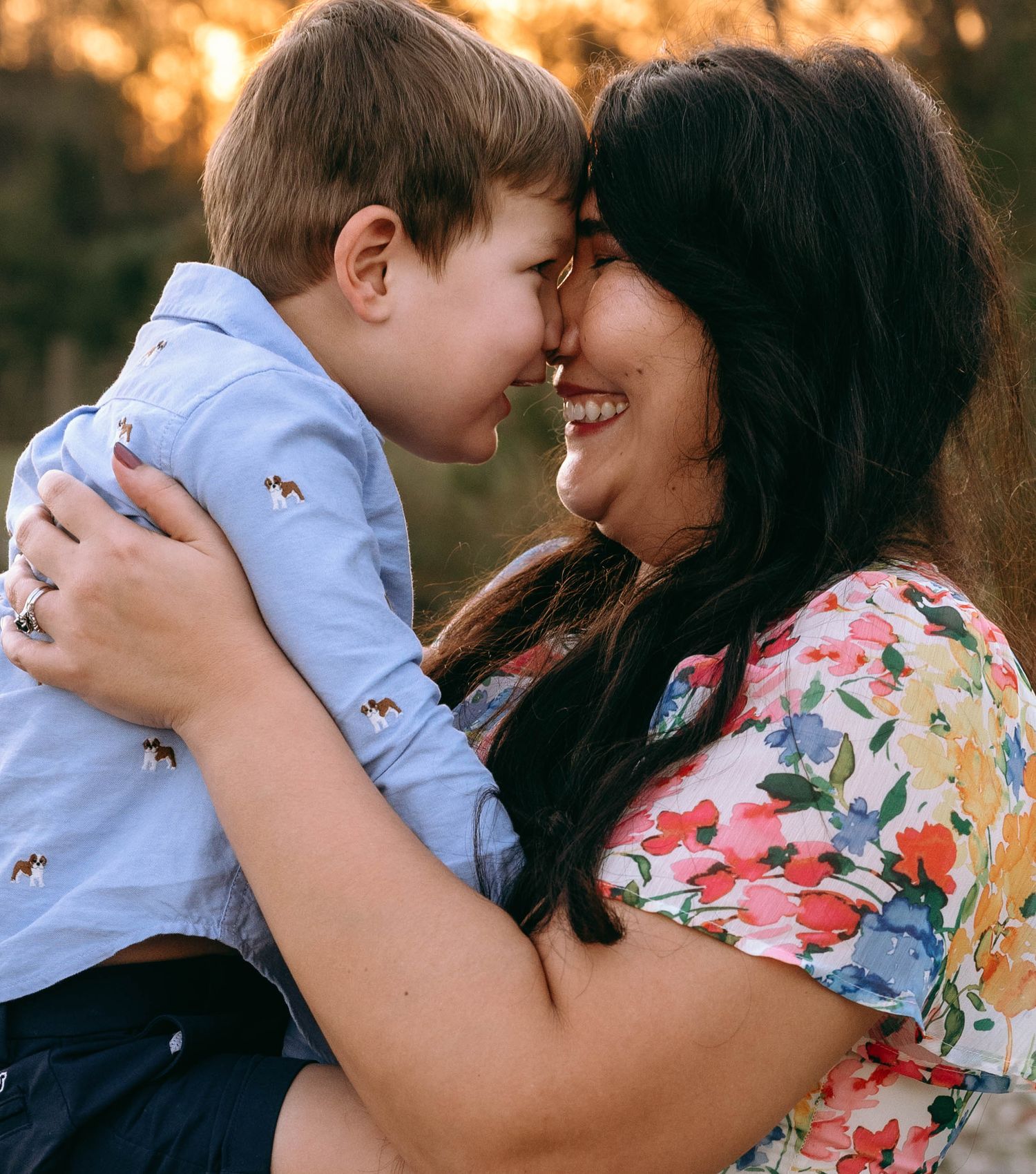Intimate family portraits showing tender moments and hugs in warm evening light.