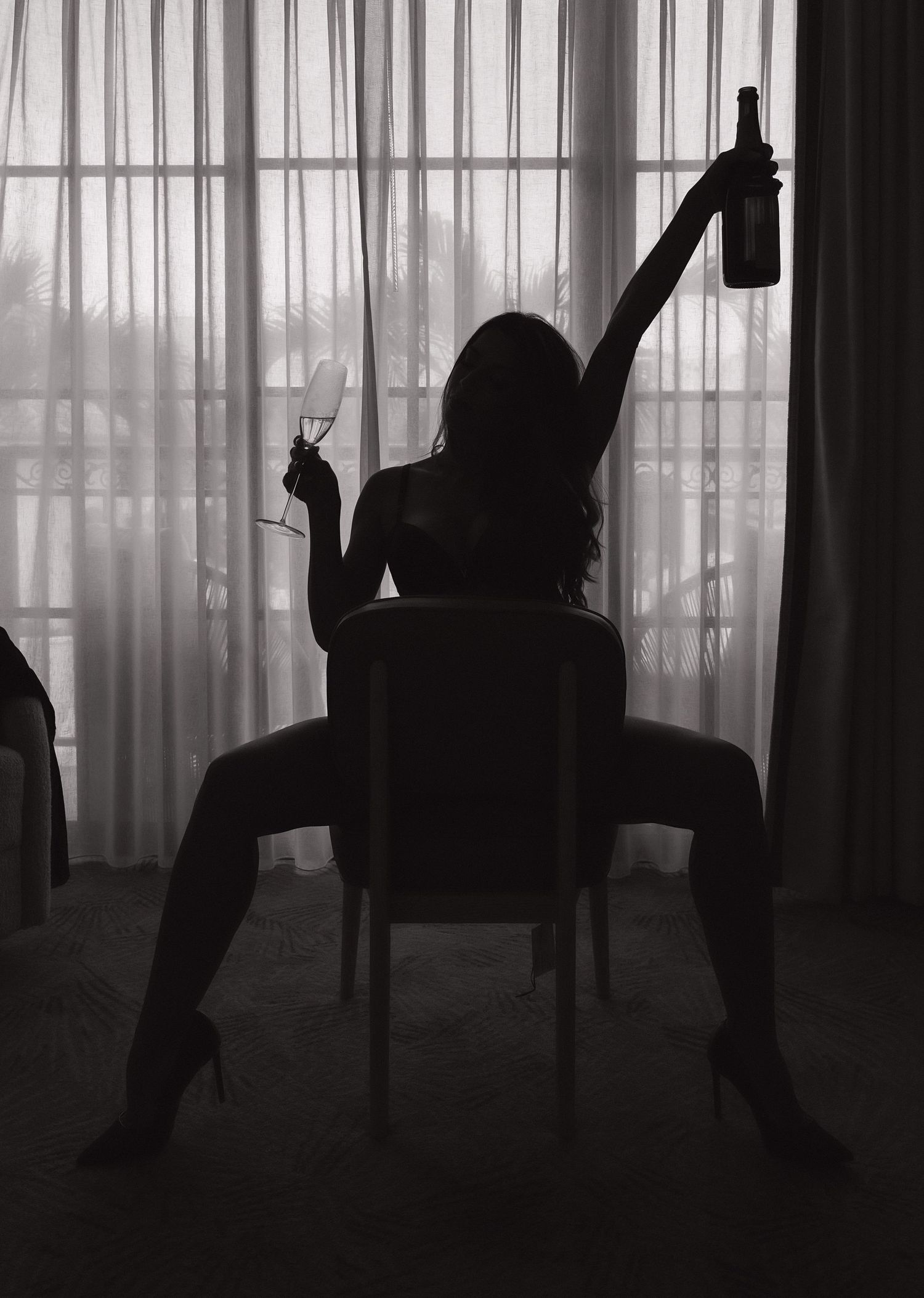 Silhouettes dancing behind sheer curtains create dramatic shadows.