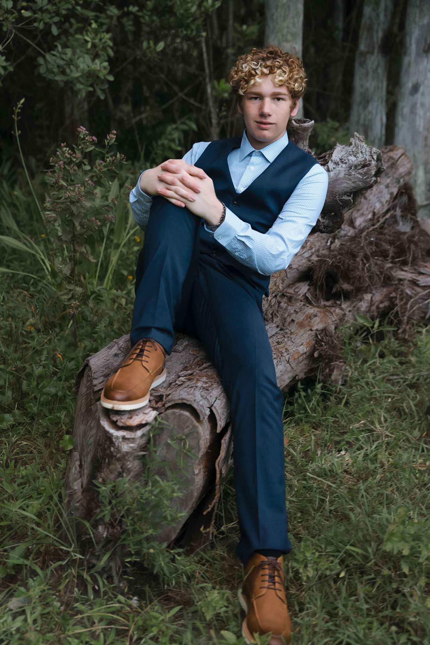 Stylish poses in formal attire with brown leather shoes against natural backgrounds.