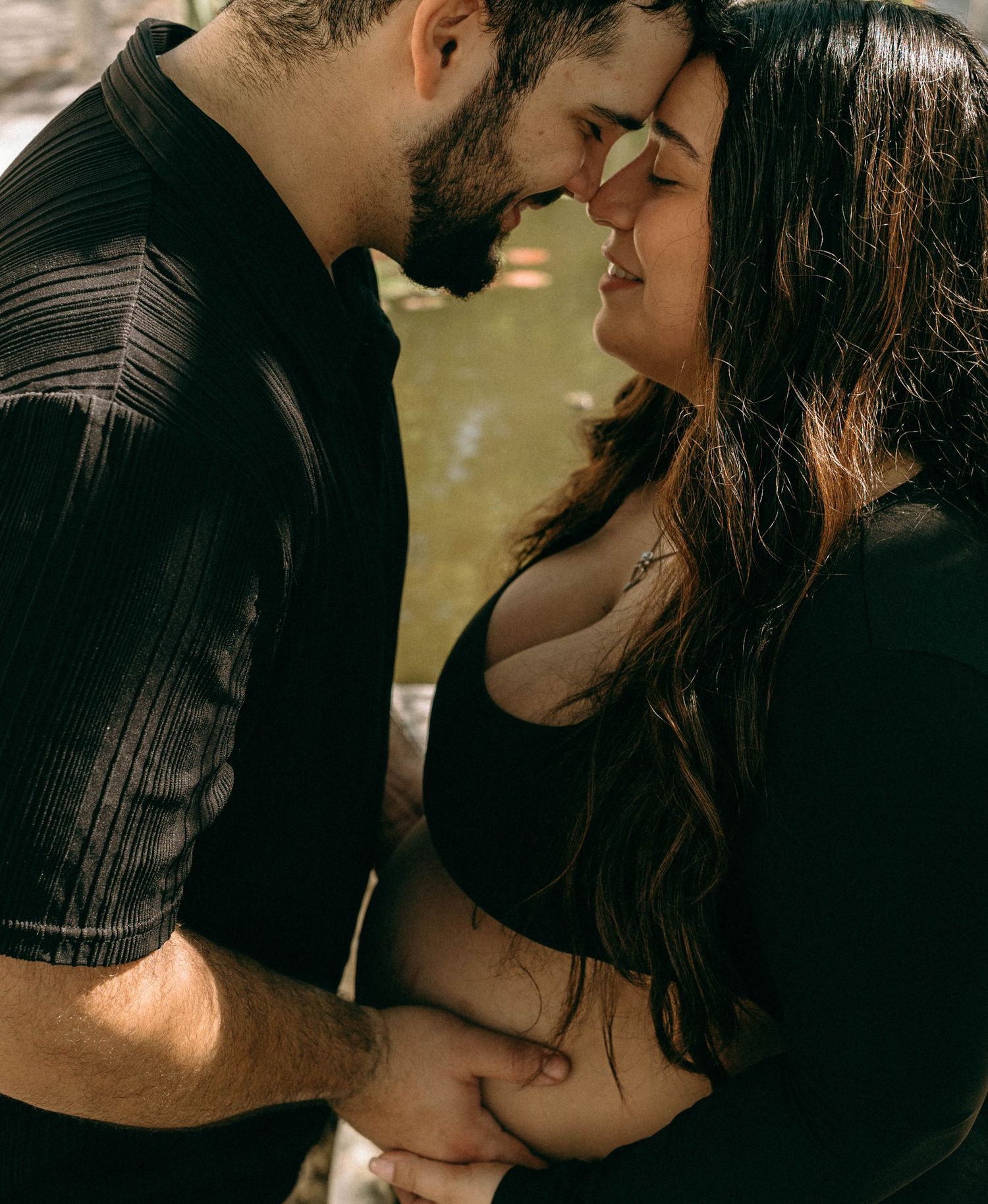 Romantic couple in black sharing an intimate moment, almost kissing outdoors. Worth Avenue, Palm Beach, FL