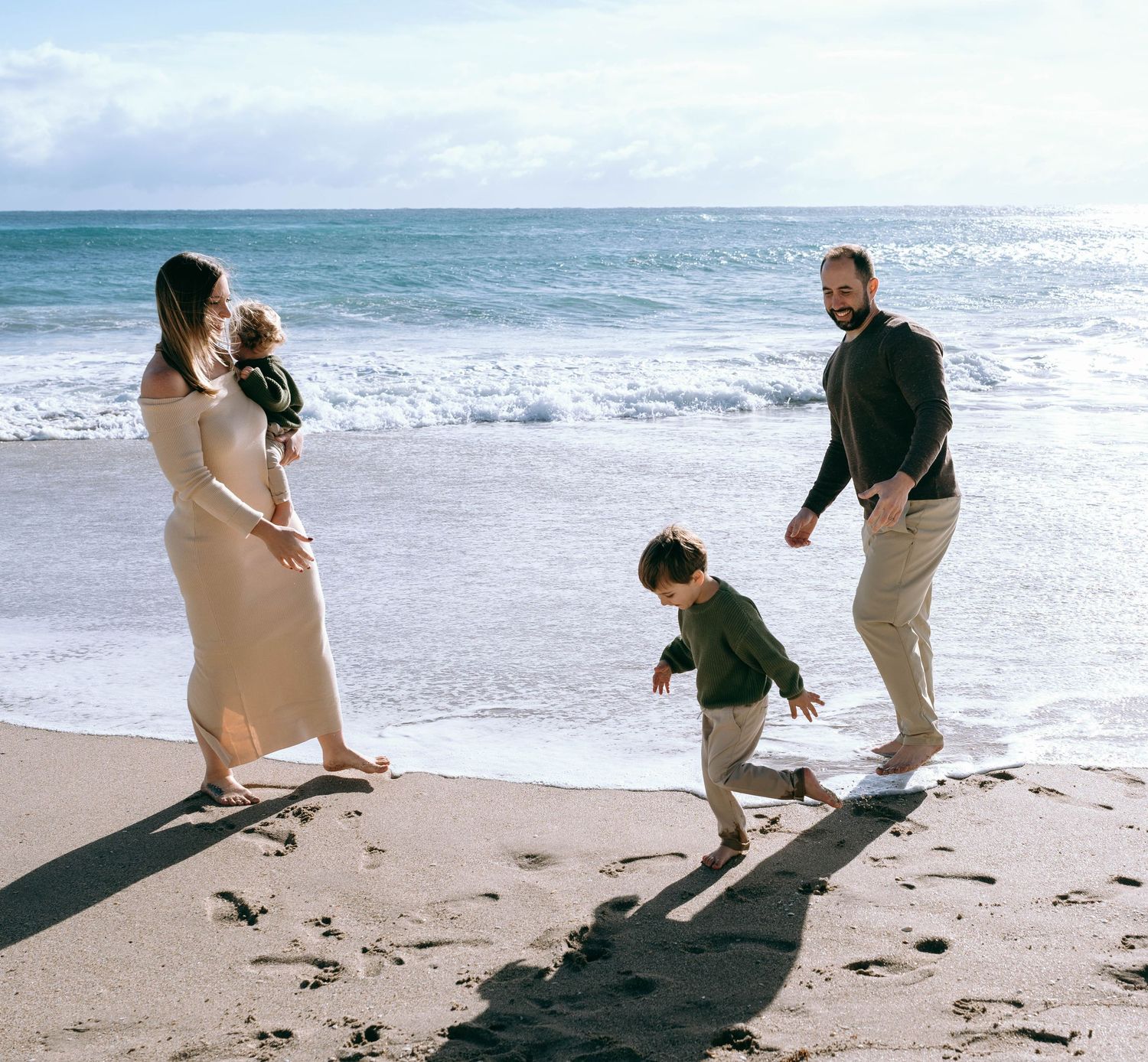 People enjoying a playful moment while walking along the sandy beach.