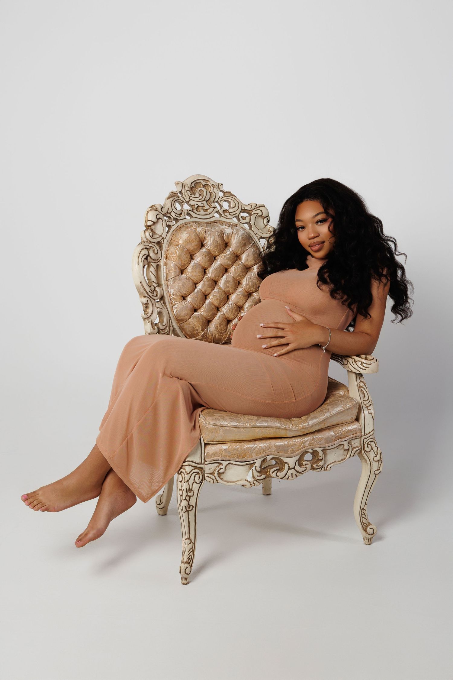 Artistic boudoir photo series featuring elegant poses on an ornate vintage beige chair against white background.