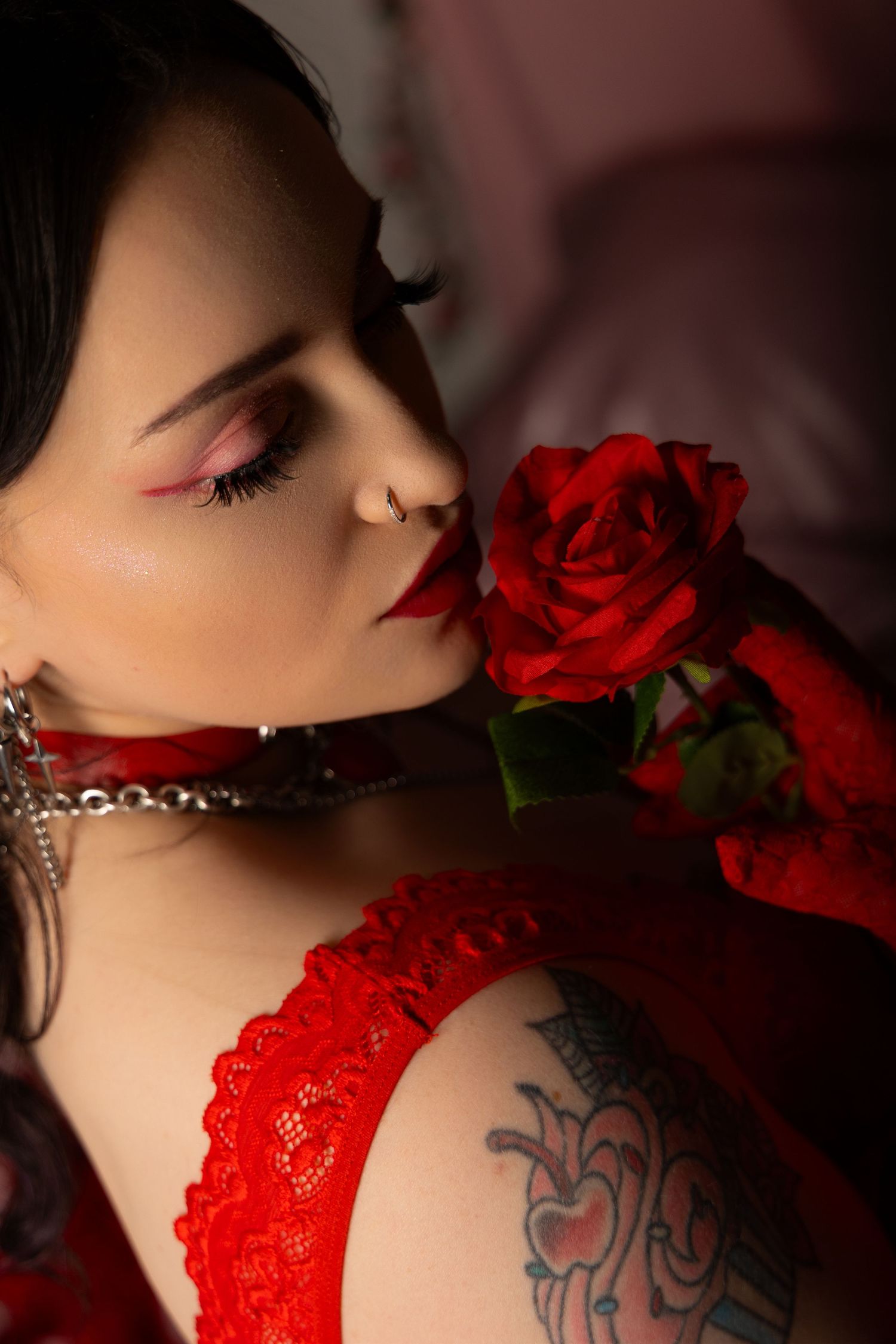 A series of artistic boudoir photos featuring red lace lingerie, roses, and a visible tattoo in moody lighting.
