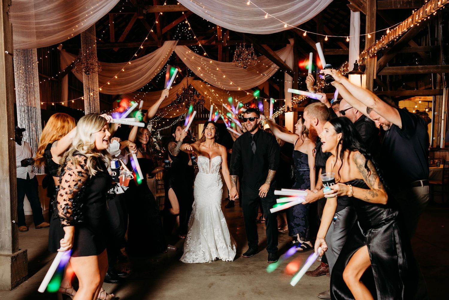 Wedding reception dance party with string lights and guests dancing in The Marion Barn wedding venue.
