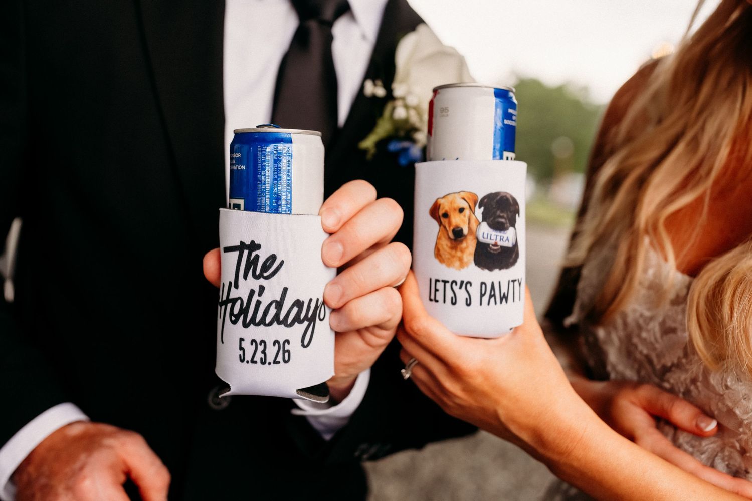 Custom wedding can koozies reading The Holidays 5.23.26 and Lets Pawty with cute dog illustrations.