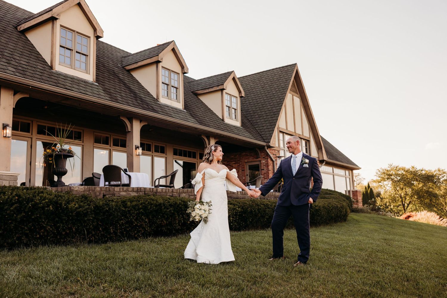 The Covered Bridge Golf Course wedding venue exterior with Tudor-style architecture and covered walkway.