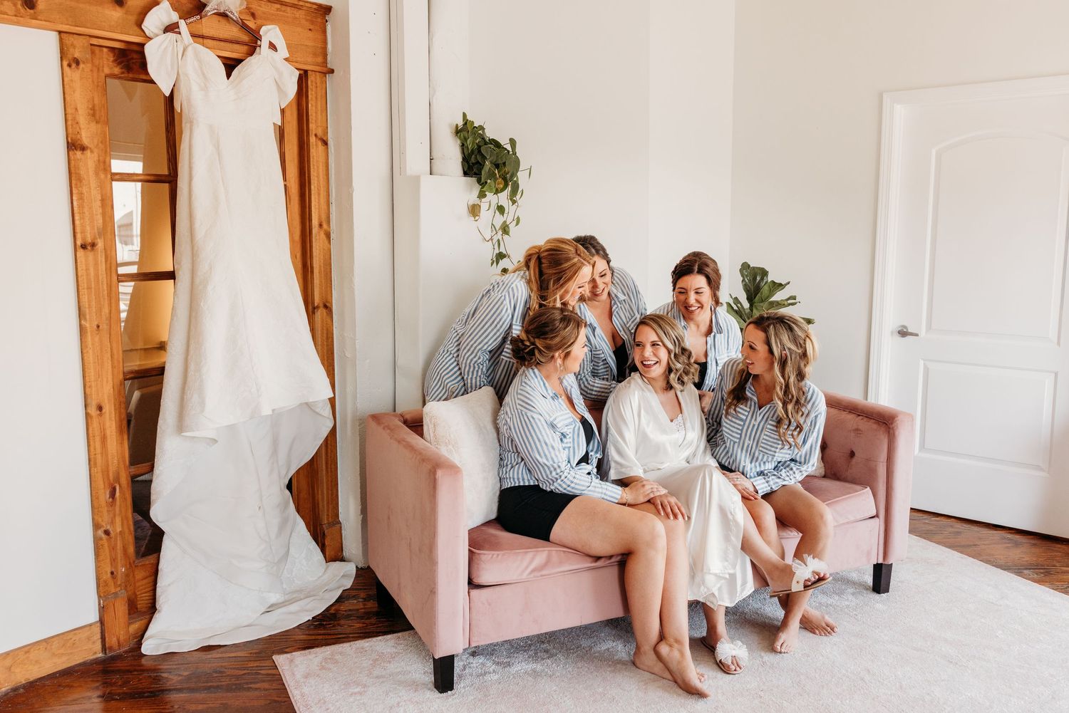 Getting ready moments captured in bright room at BeautyLou with bridesmaids.