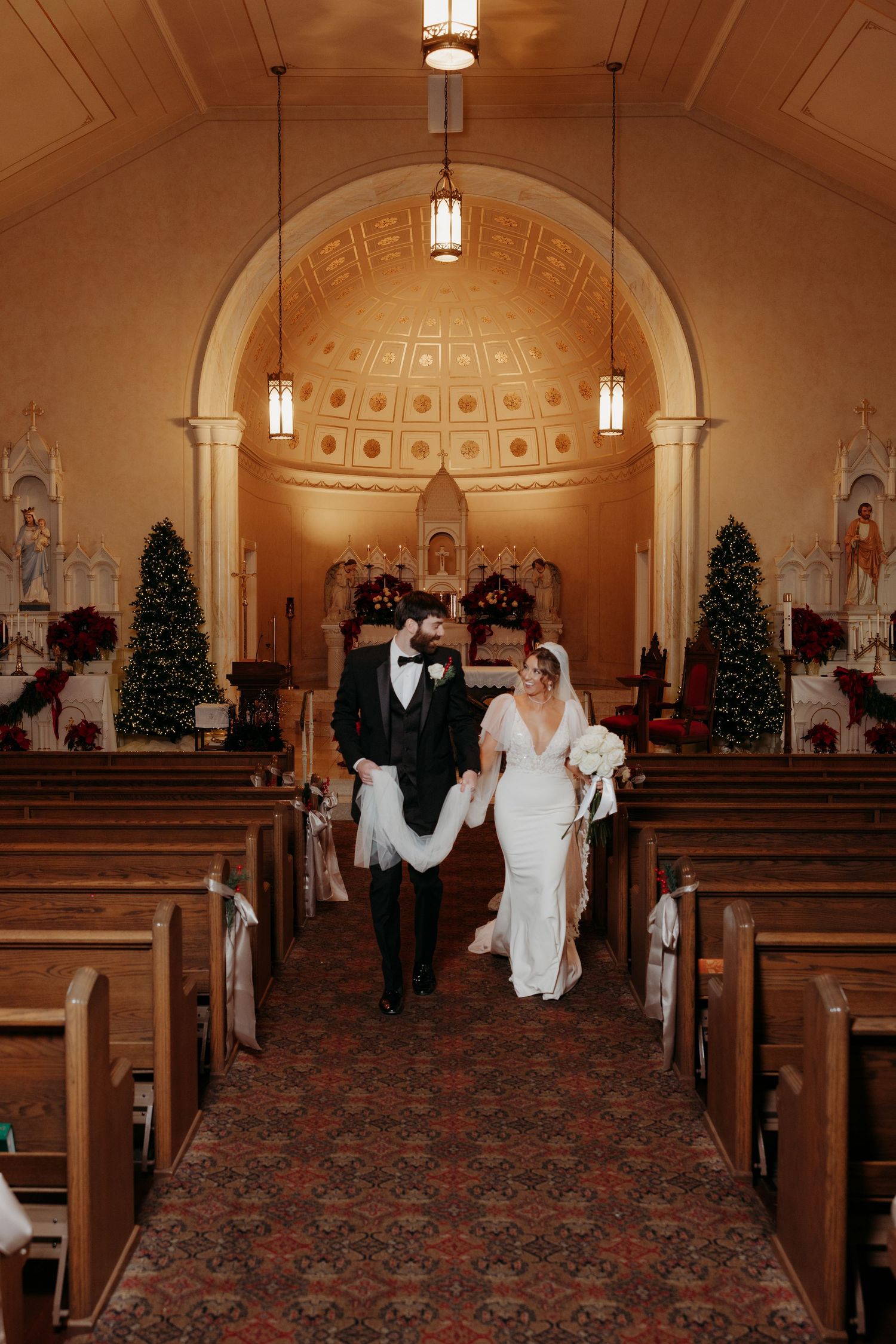 Wedding ceremony in a Springfield, KY church with domed ceiling and traditional wooden pews.