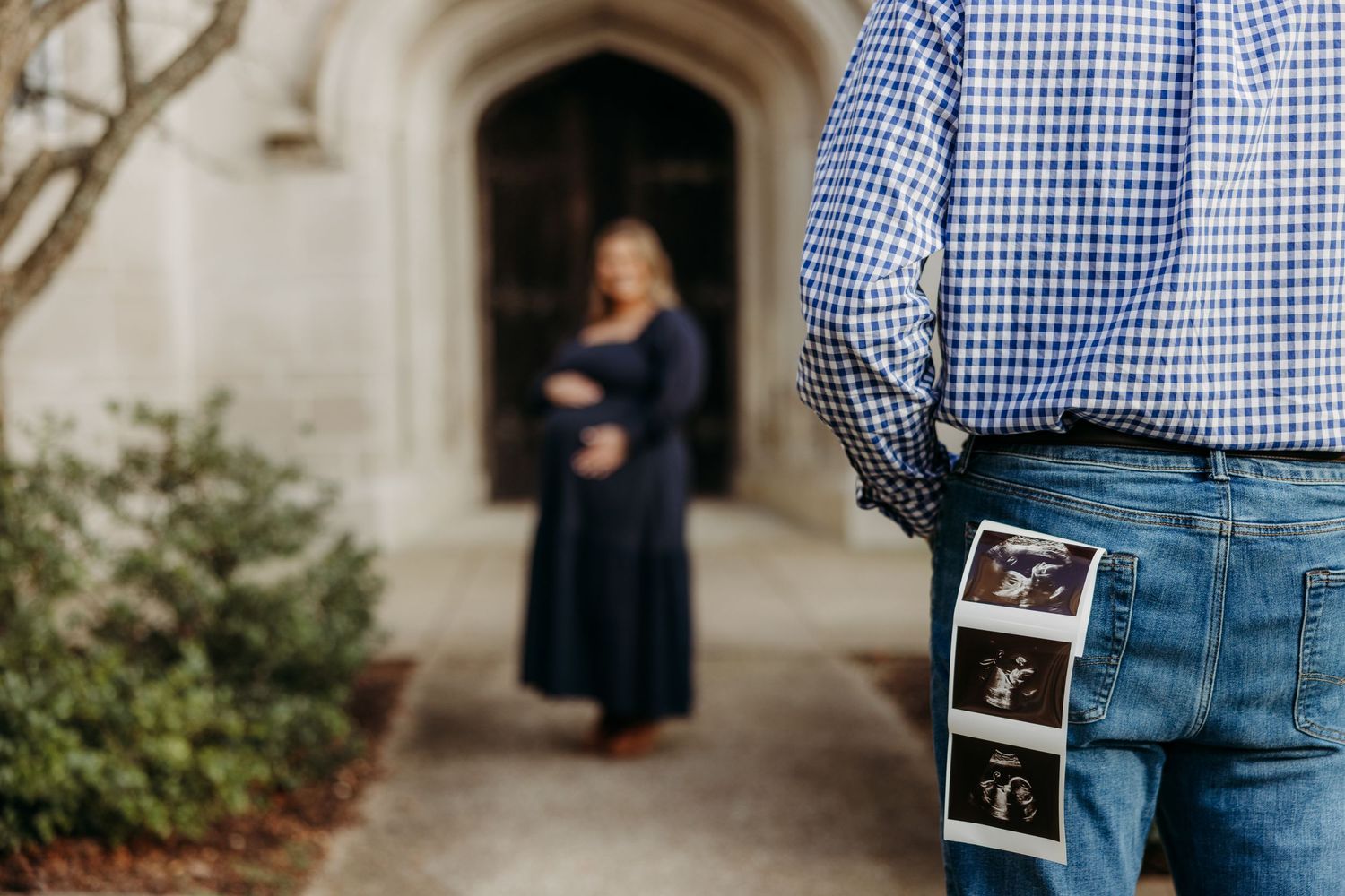 Pregnancy announcement photos with ultrasound image against stone archway.