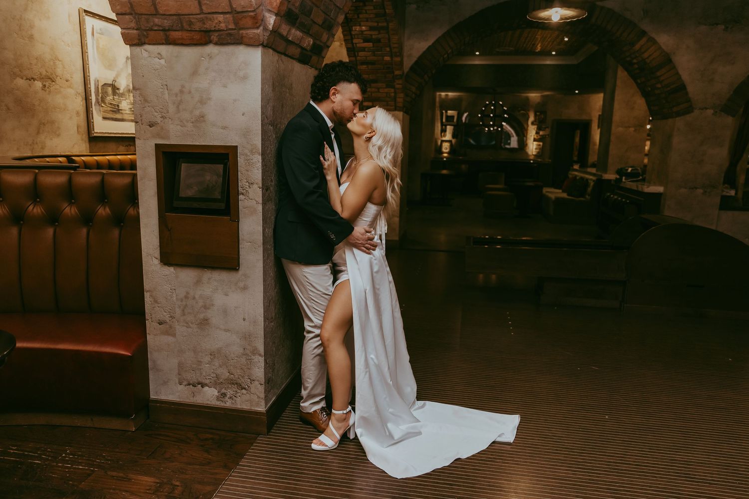 Atmospheric underground venue with brick archways and mood lighting.