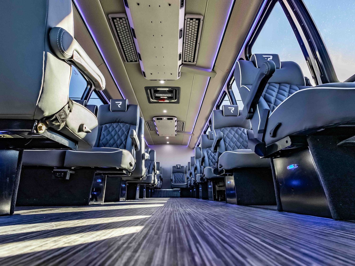 Interior view of a modern coach bus showing plush seats and luxurious cabin design.