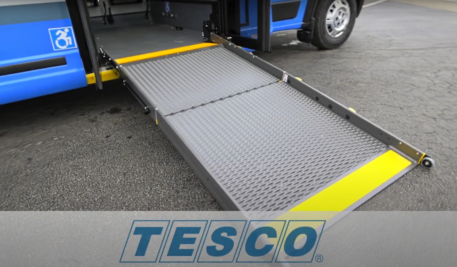 Wheelchair accessibility ramp extending from a TESCO transit bus.