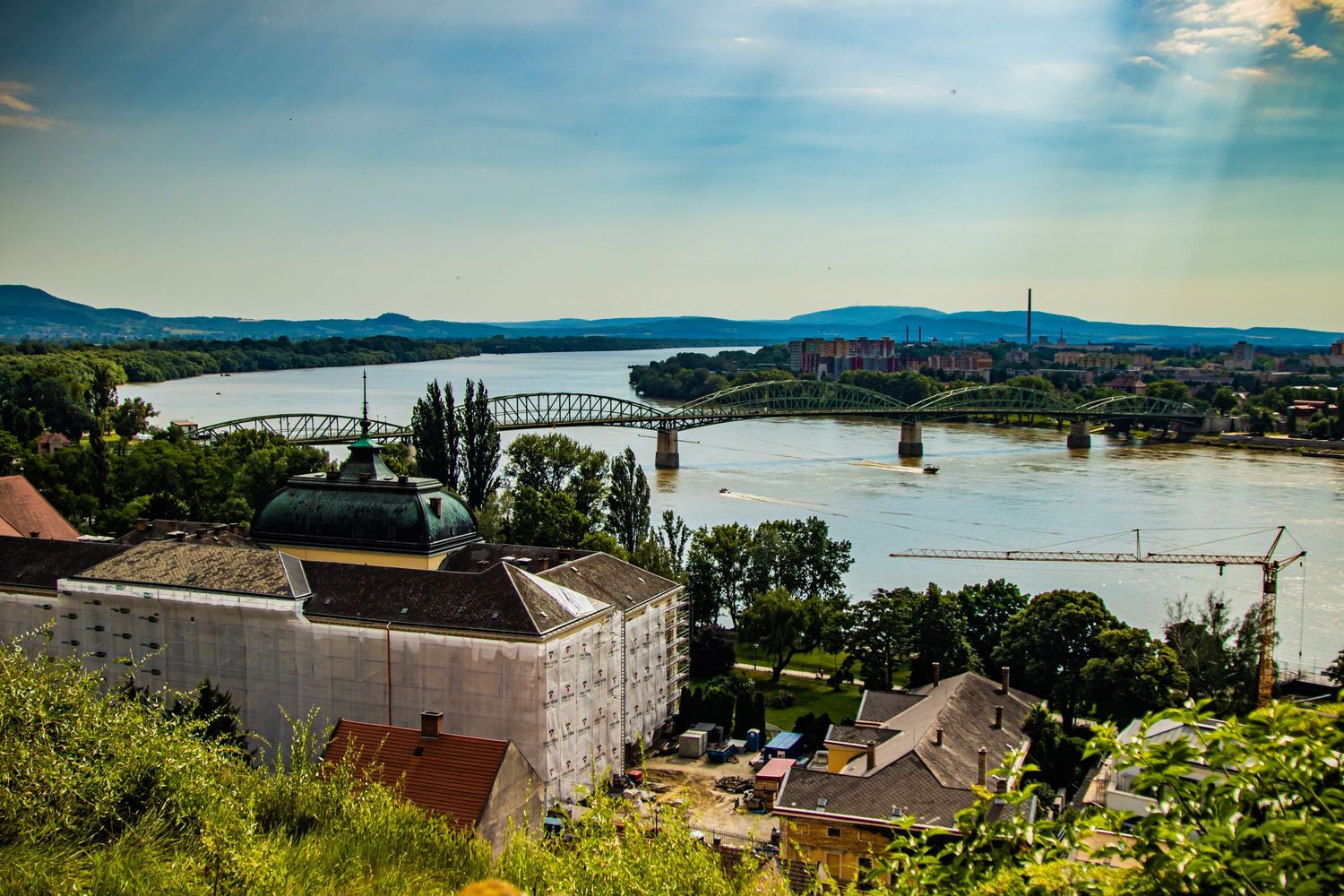 Scenic riverside view of Budapest with bridges and buildings along the Danube River.
