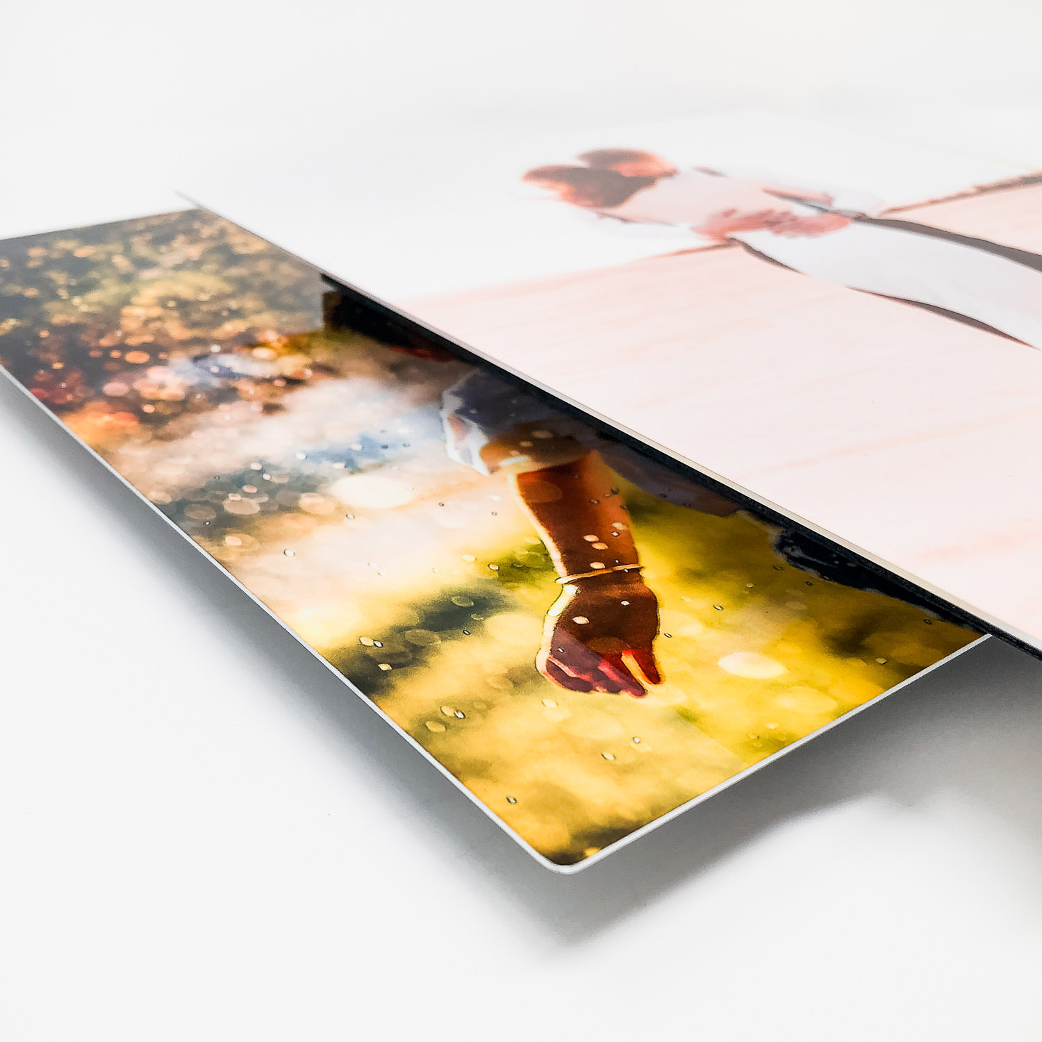 Multiple metal prints arranged in a cascading layout on a white background showing a golden sunset scene.
