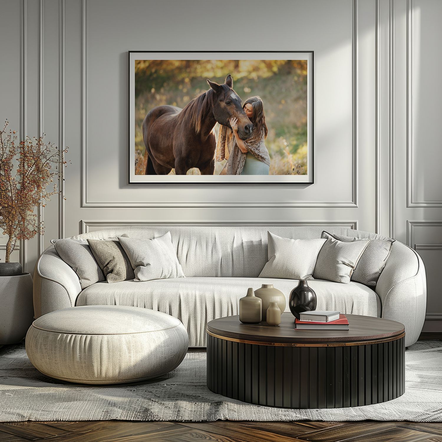 Modern living room interior with curved white sofa and round coffee table against gray paneled walls with a large horse and rider print.