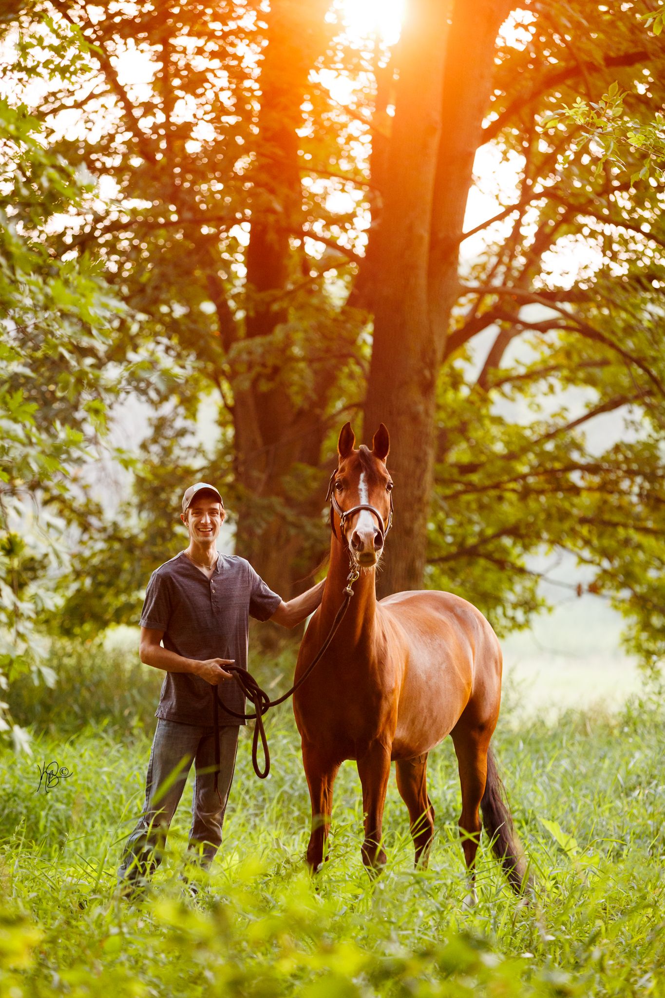 Edited final portrait of a guy and his half arabian horse, in a sunset forest setting