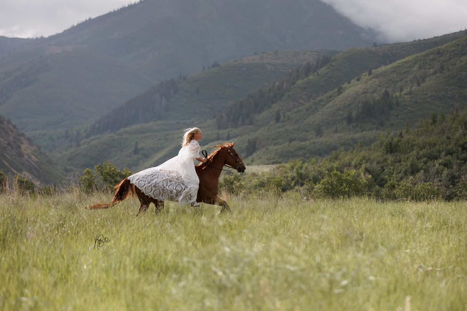Cowgirl bride galloping through the mountain fields