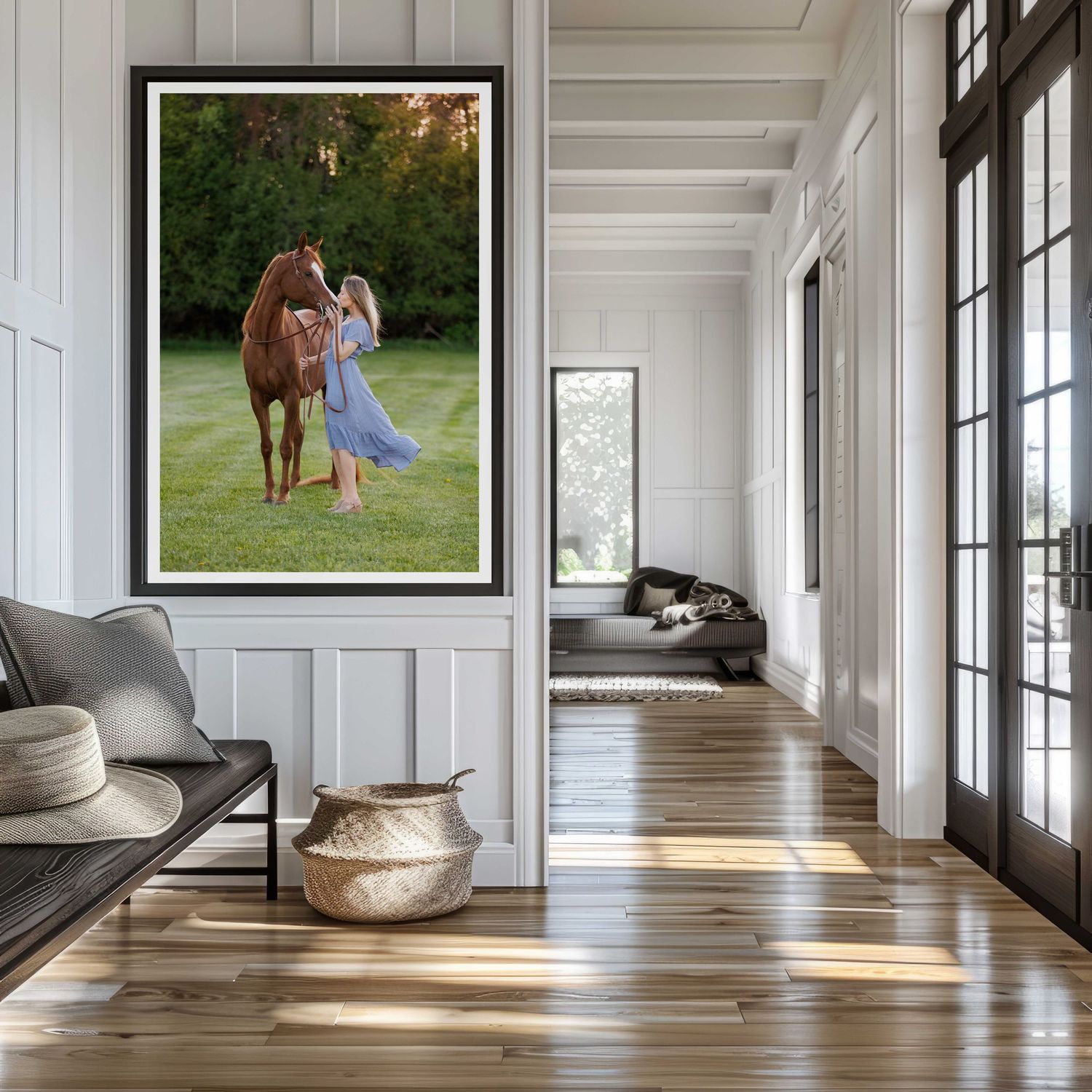 A modern sunlit hallway with large windows and a large framed horse photograph on white walls creates an elegant gallery-like atmosphere.