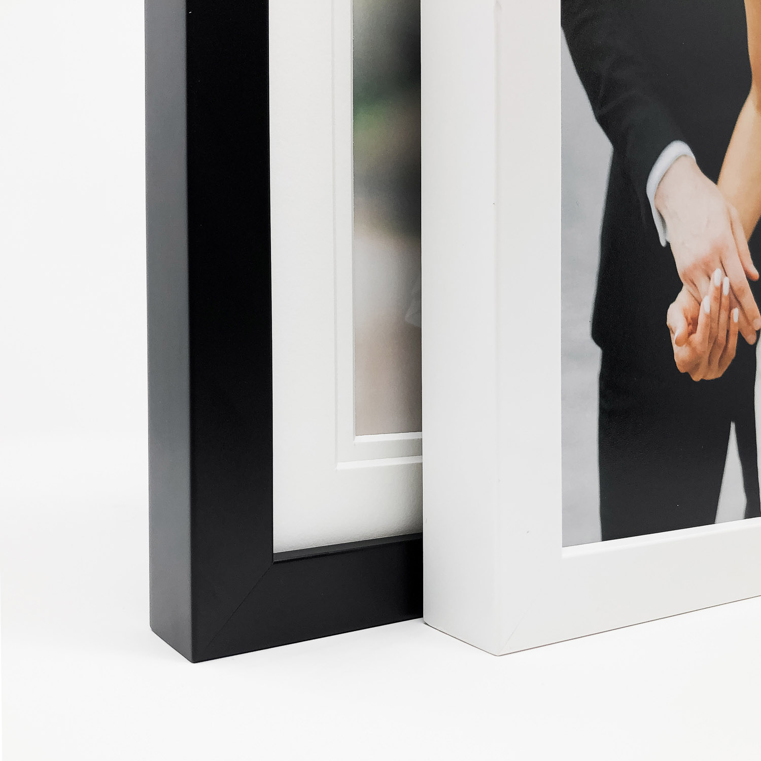Black and white minimalist closeup of gallery framed photos.