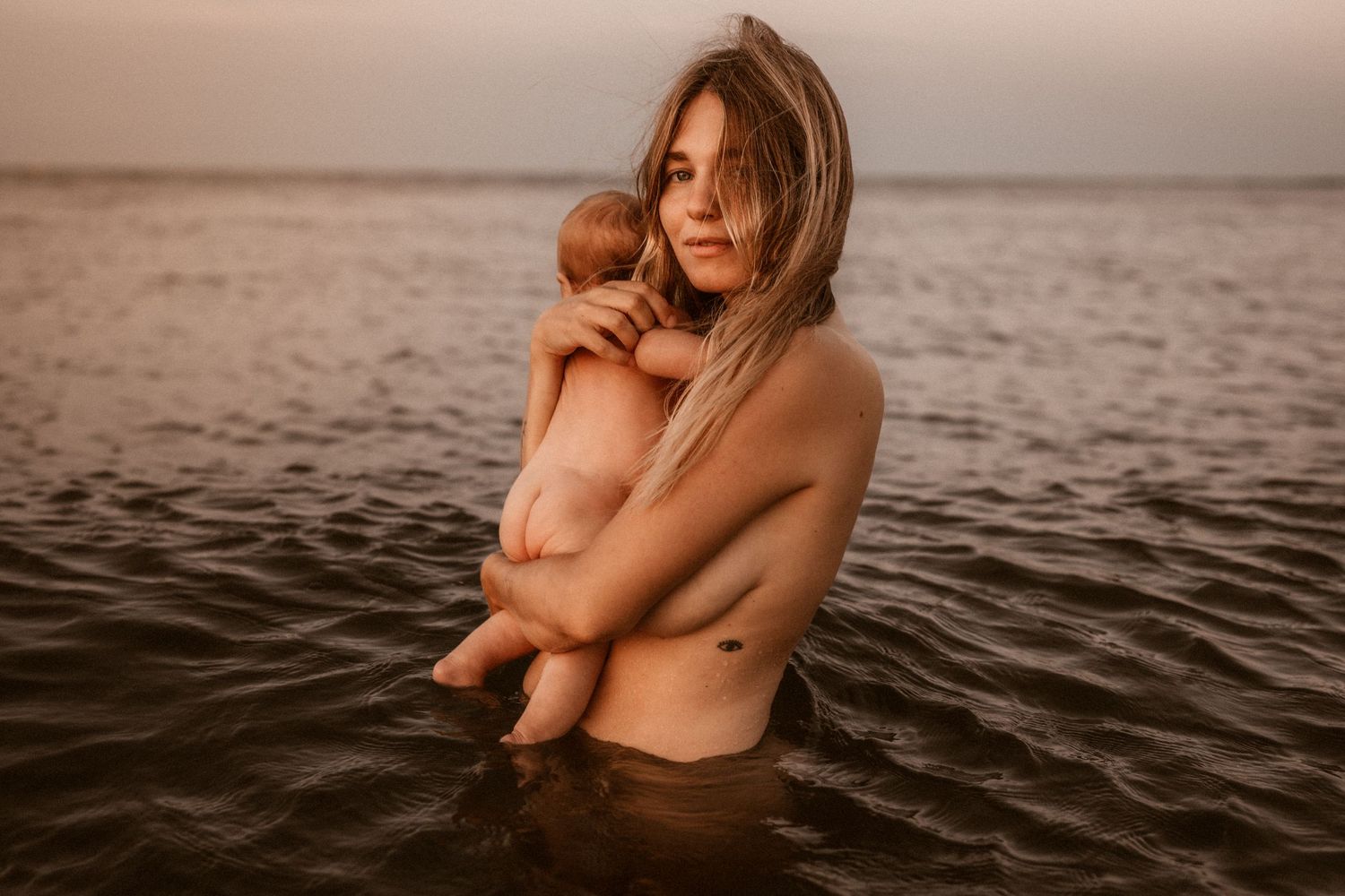 Family photographer in Javea capturing authentic moments of laughter and love at the beach
