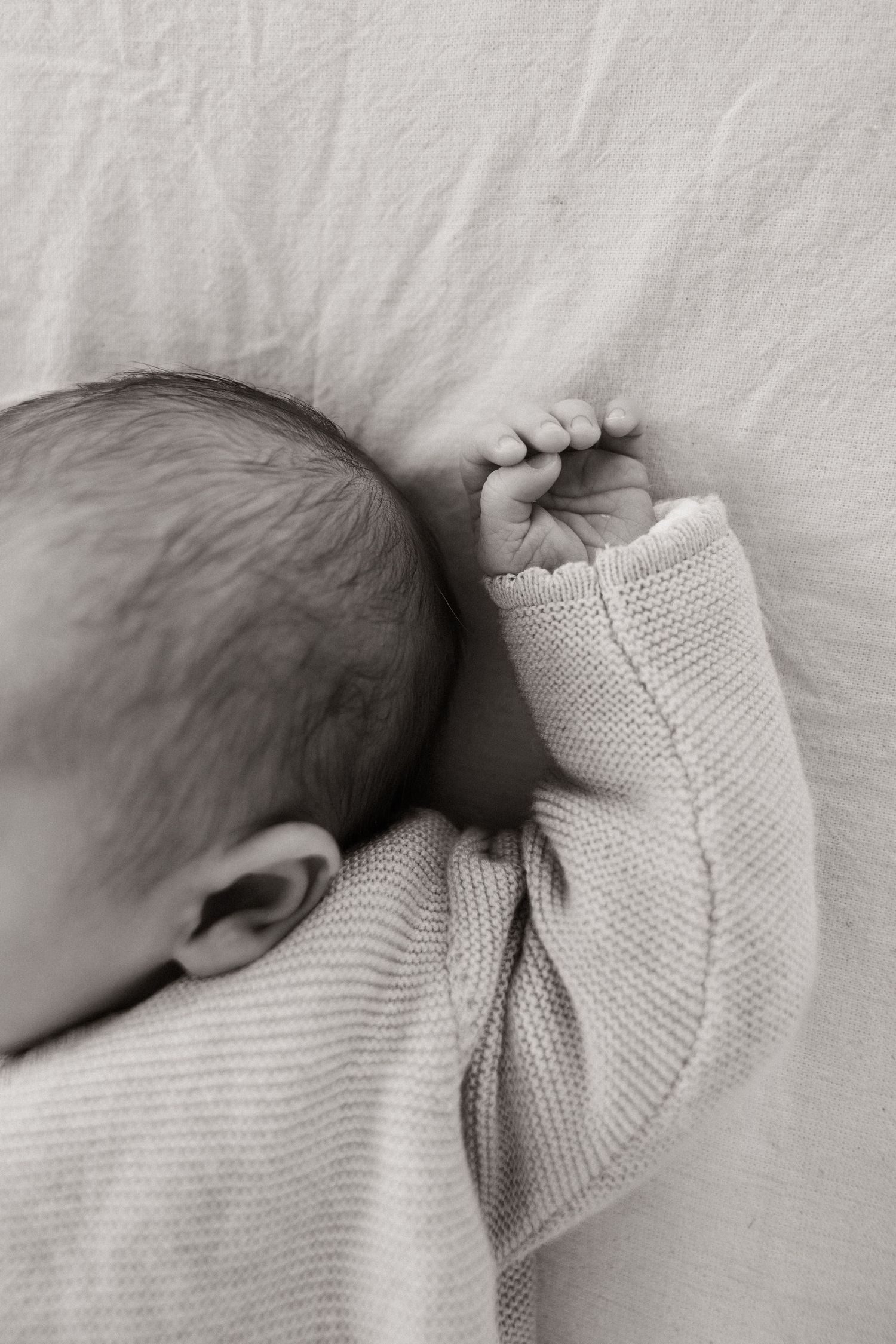 Detail shot of newborns hands and ear during in home  session.