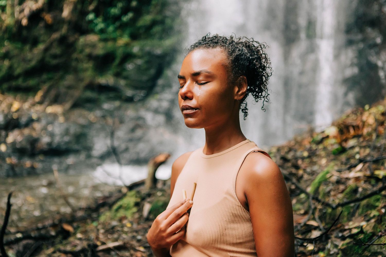 Solo photo session, a woman in front of a waterfall in Vilcabamba, Ecuador embracing the moment