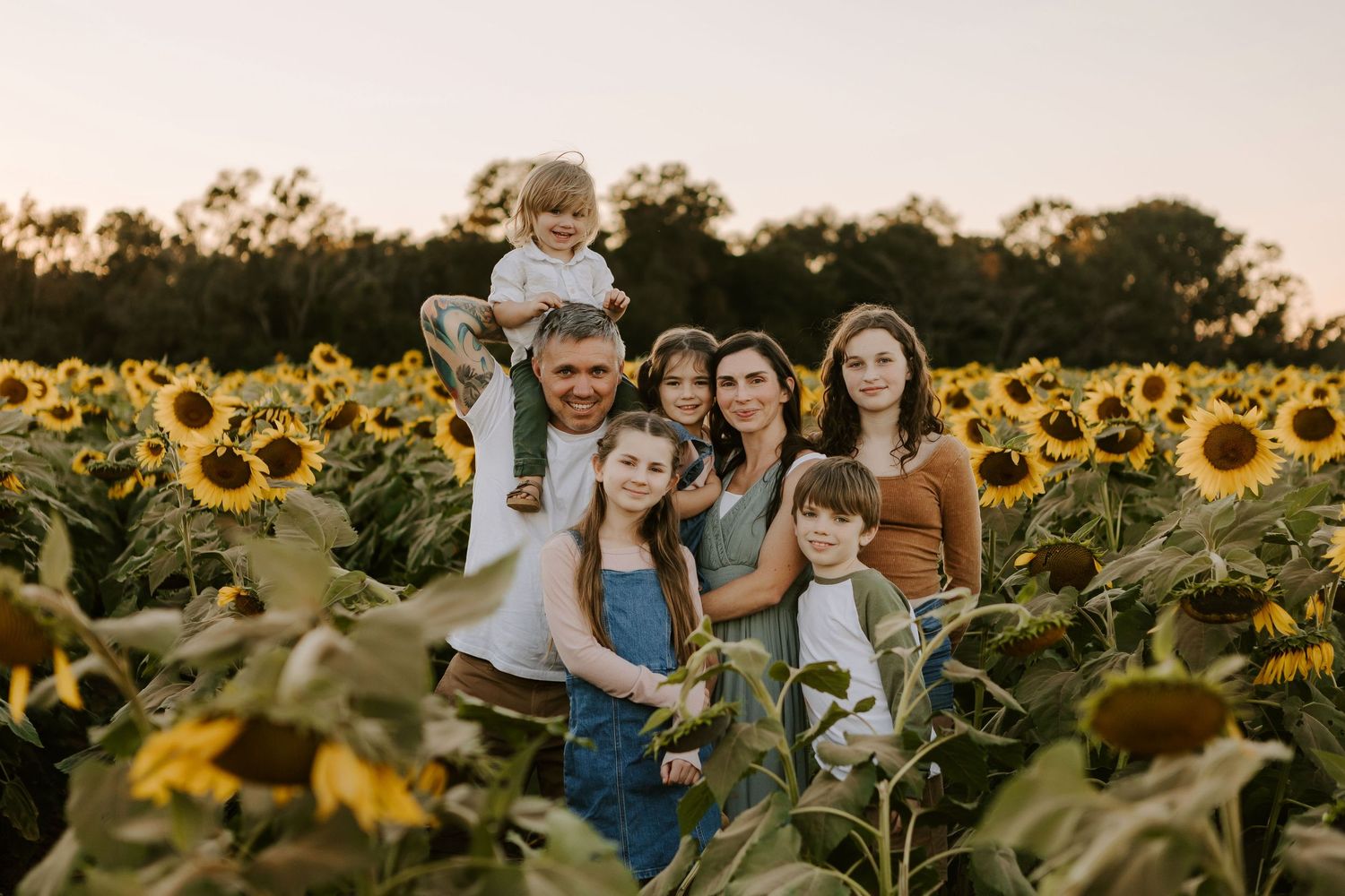 Family photo session in Milton, Florida of a beautiful family in a sunflower field