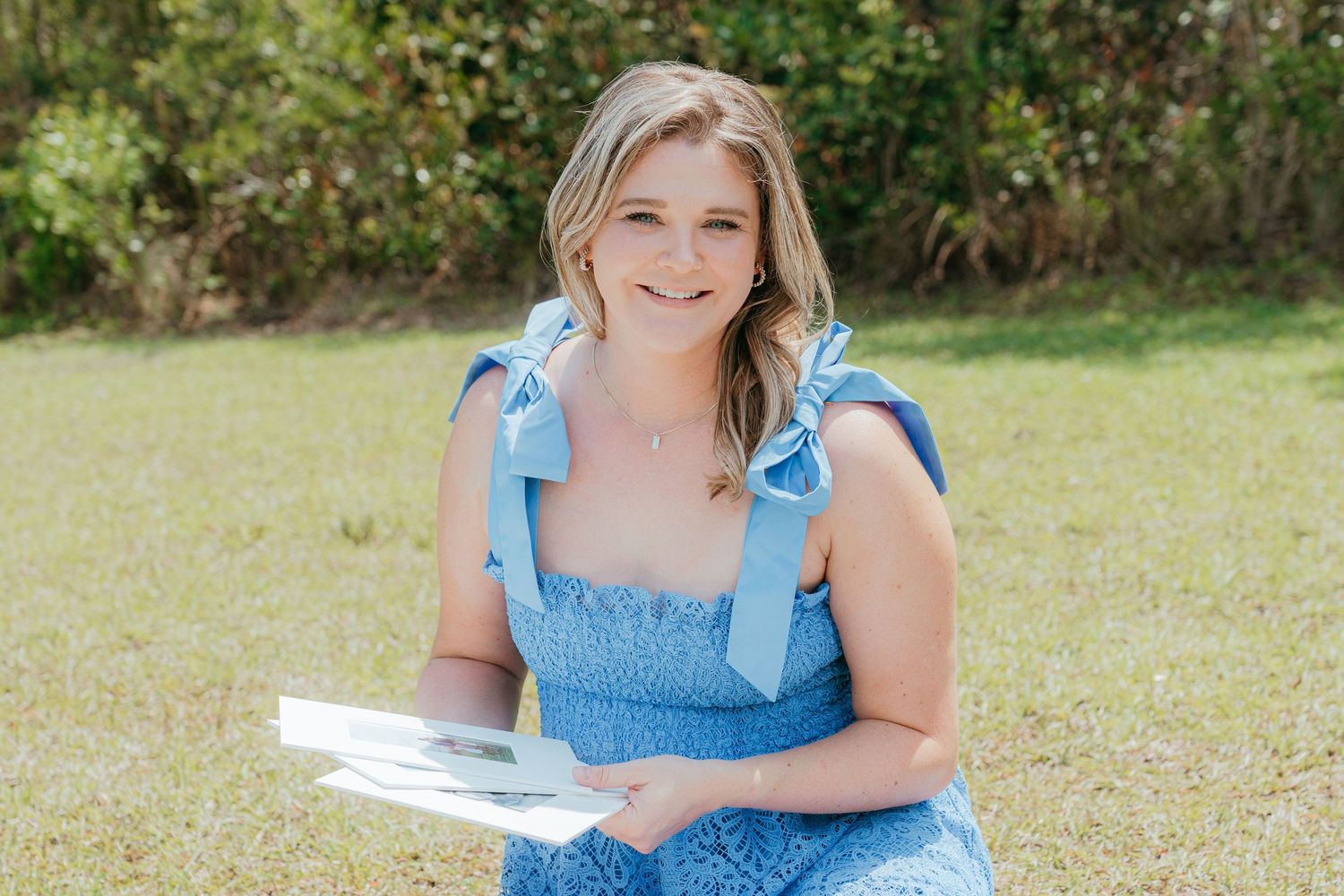 Lindy Rebro Photo holding heirloom portraits she took for clients in Brunswick, Georgia, in Sea Island, Saint Simons Island and Jekyll