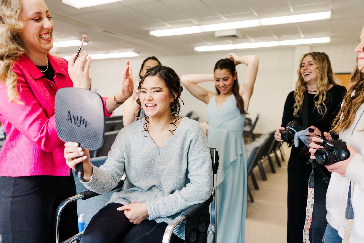 weddings moment during wedding preparations with bridesmaids in a dressing room.