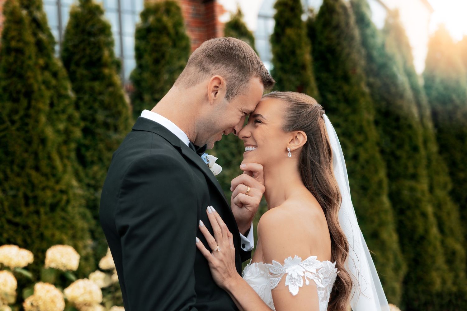Groom holds bride close with hand under chin. Metro Detroit Wedding Photographer St. Clair Novi Detroit Plymouth Howell Cement City MI