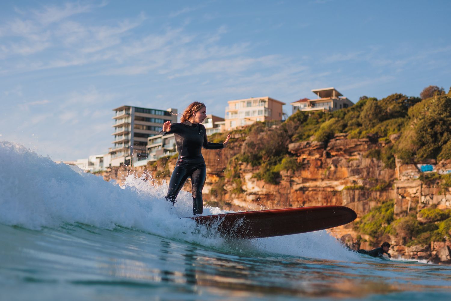 Surfer turning a longboard in the whitewater