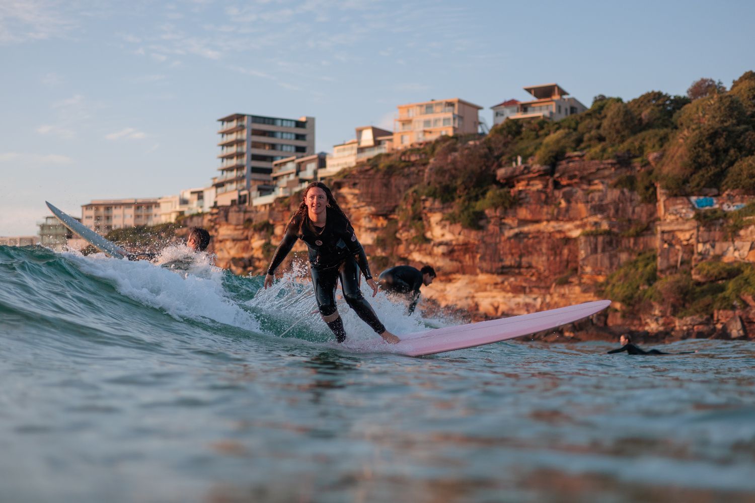 Surfer bottom turning on a longboard