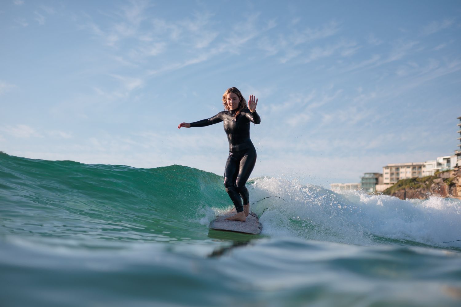 Lady Surfer cross stepping on a longboard at Freshwater Beach