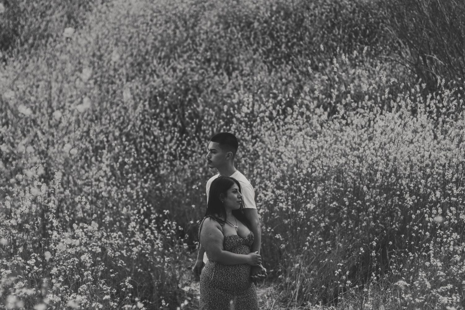 Soft grain black and white portrait, capturing a natural, unposed moment with quiet emotion.