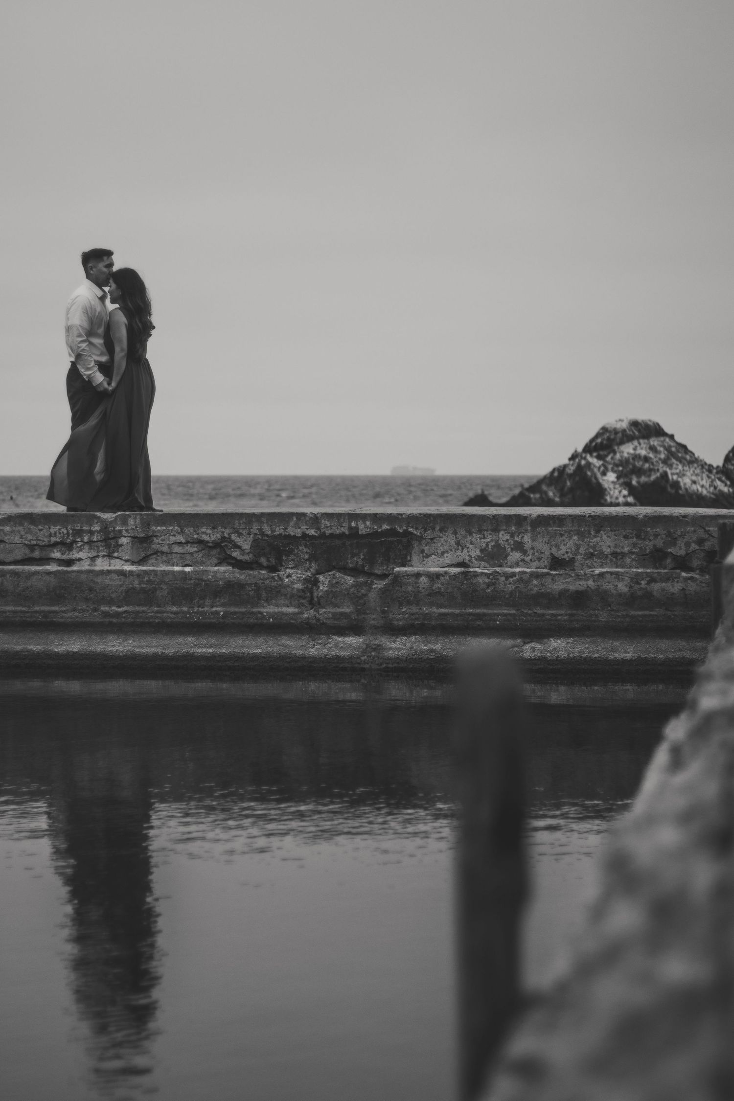 Artful black and white photo, soft blur and grain, capturing emotion during an in-between moment.
