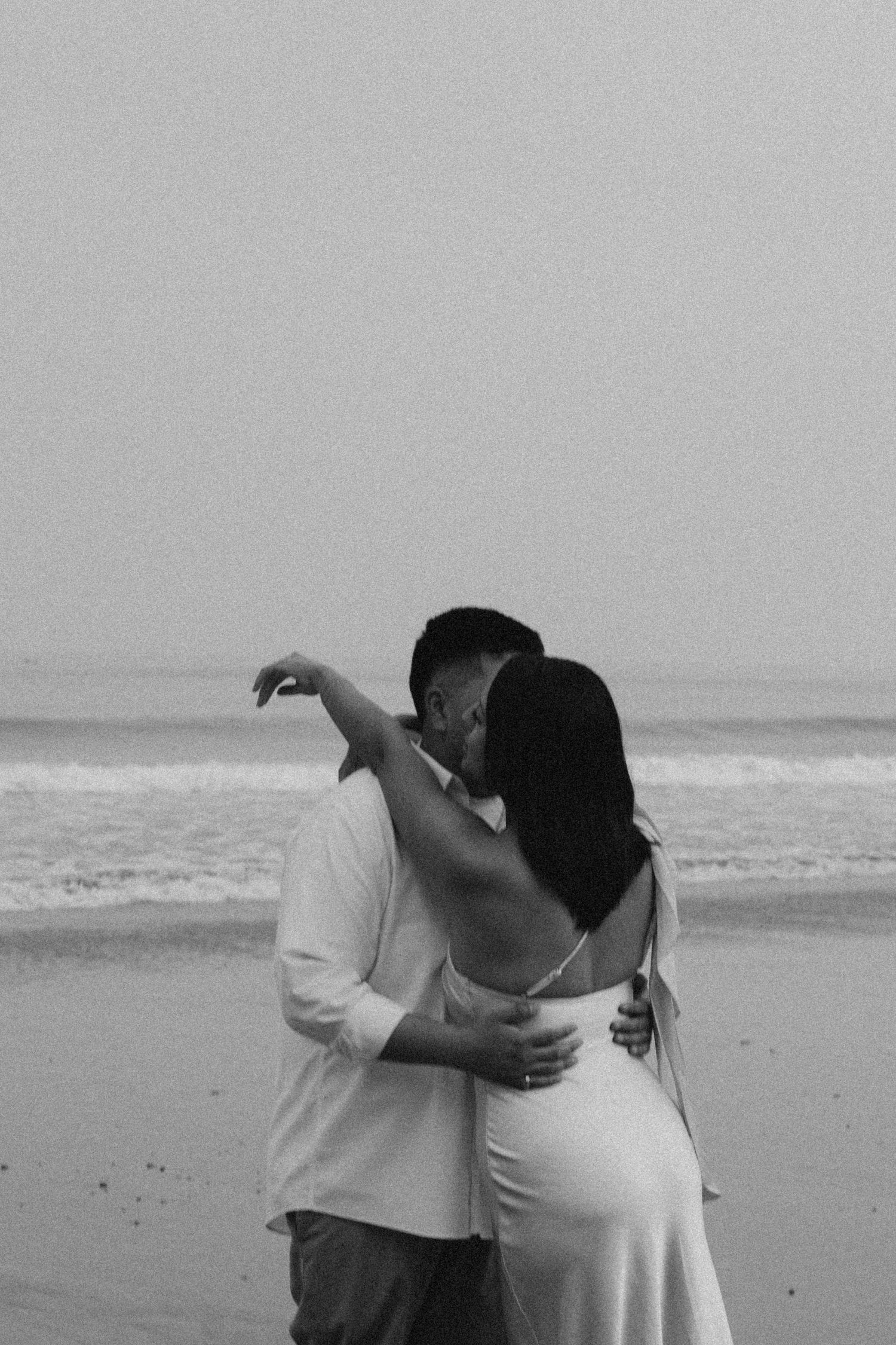 Moody, grainy black and white couple in soft natural light.