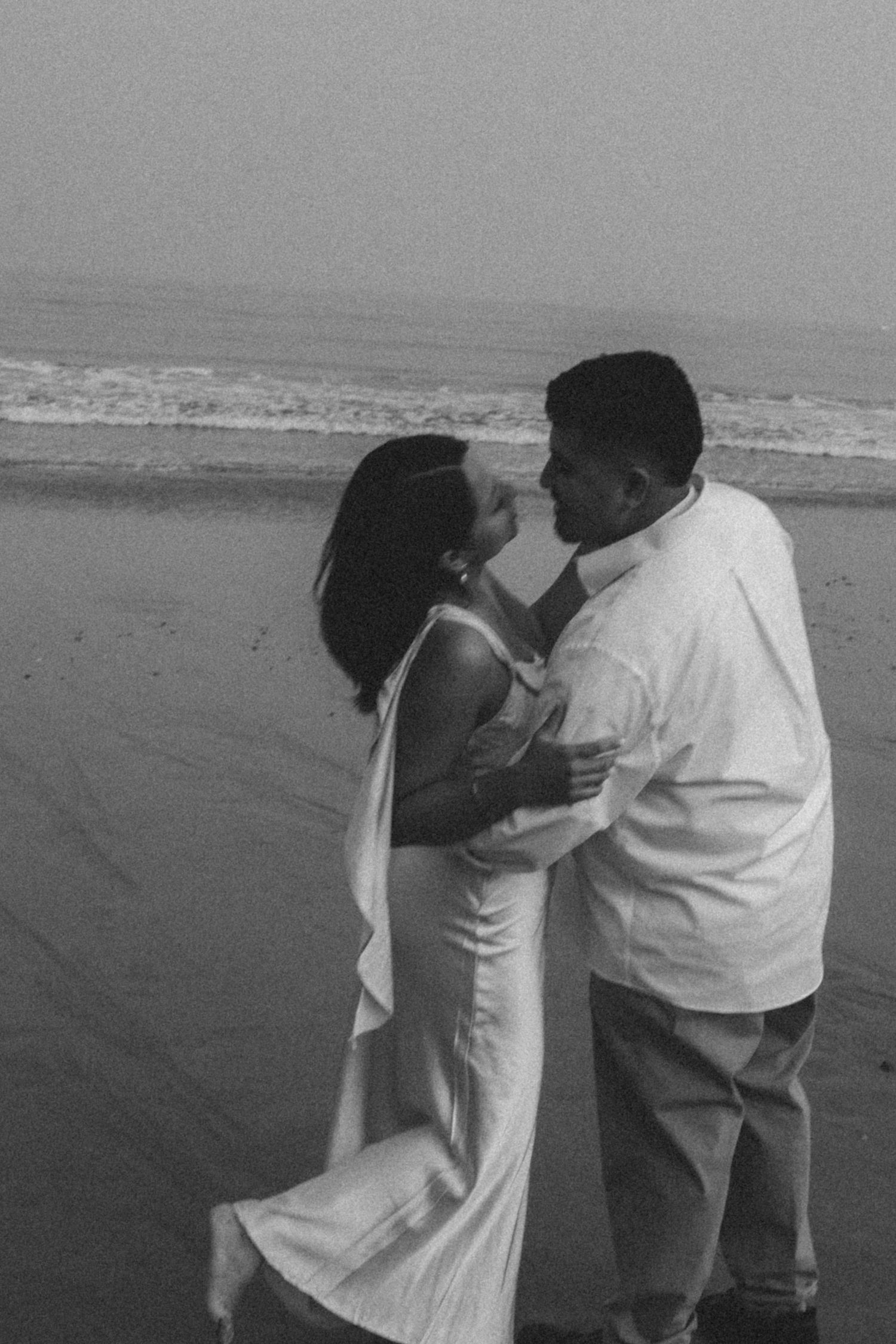 Couple in motion, soft focus and blur. A candid artful black and white frame.