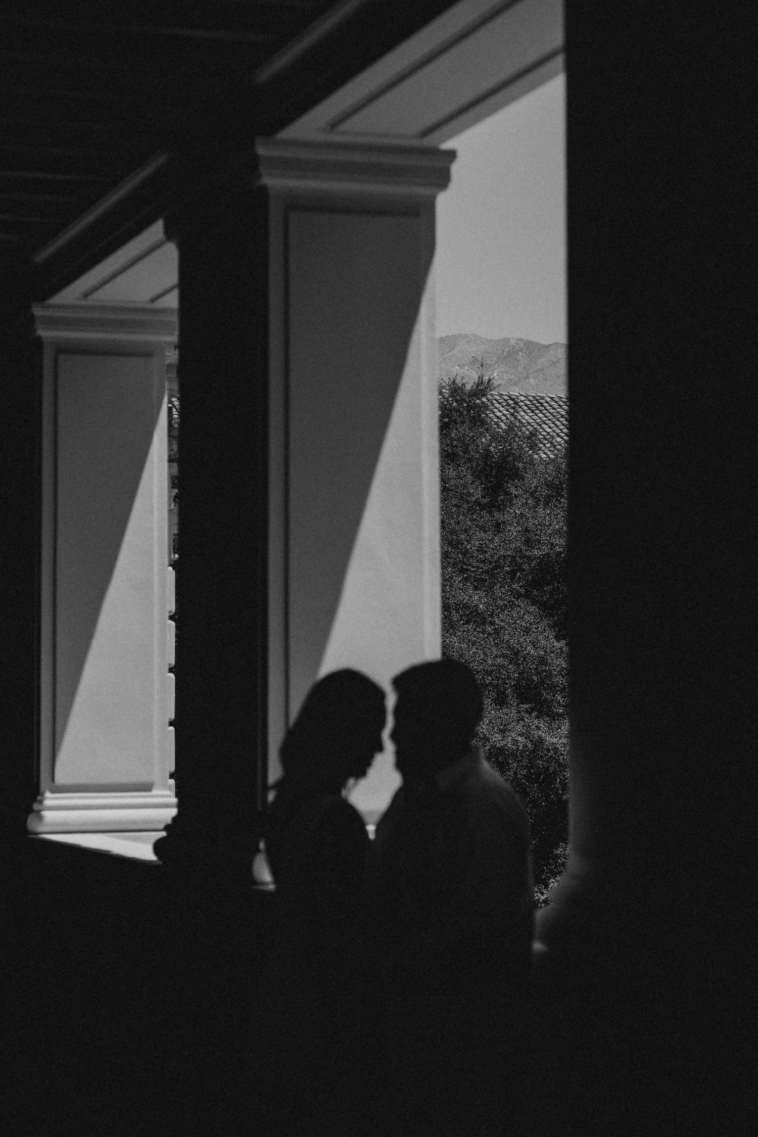 Grainy black and white photograph reflecting intimate, unposed connection between a couple.”
