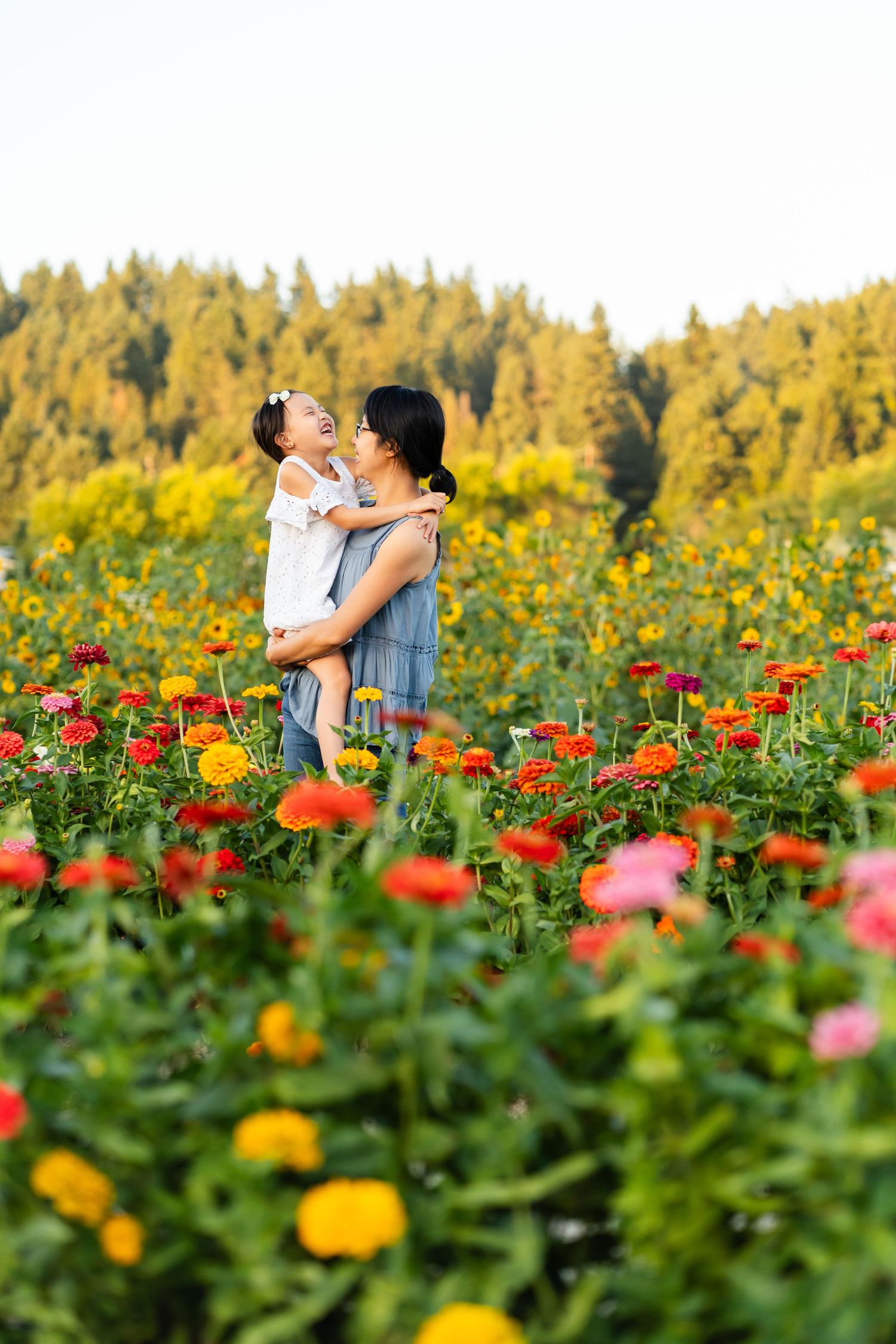 Mother daughter laughing at sunset in a flower field near Redmond