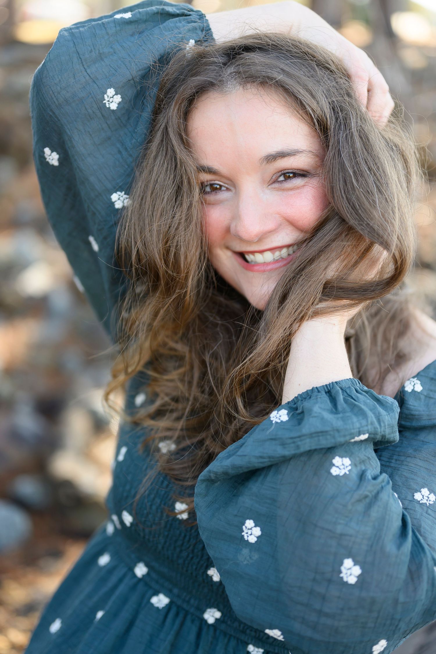 A series of photos showing someone wearing a navy blue floral patterned hoodie while posing playfully outdoors.